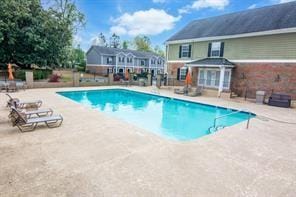 outdoor pool featuring a patio area