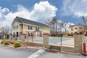 pool with fence and a patio