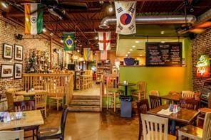 interior space with brick wall and a ceiling fan