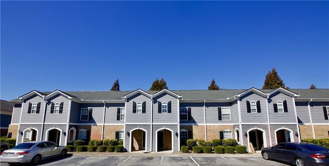 multi unit property with uncovered parking and brick siding