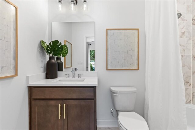 full bath featuring curtained shower, baseboards, toilet, and vanity