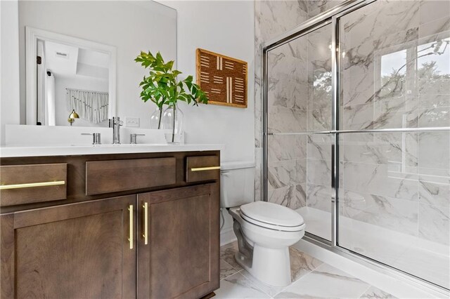 full bathroom featuring a marble finish shower, marble finish floor, vanity, and toilet