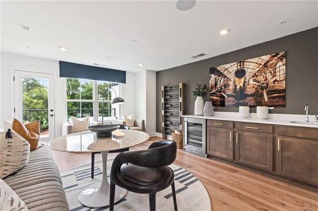 dining area with recessed lighting, light wood-type flooring, wine cooler, and visible vents