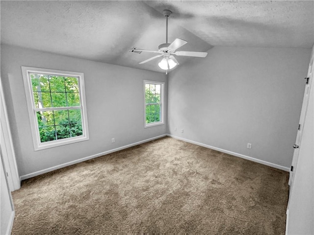 carpeted empty room with a ceiling fan, a textured ceiling, baseboards, and lofted ceiling