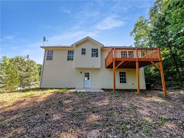 back of house featuring a wooden deck