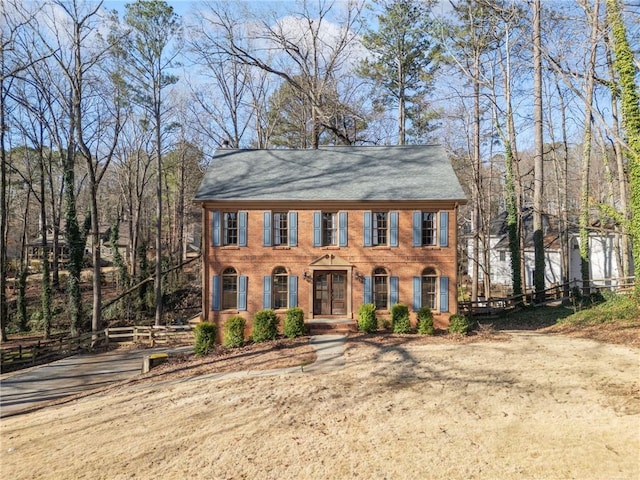 colonial house featuring brick siding