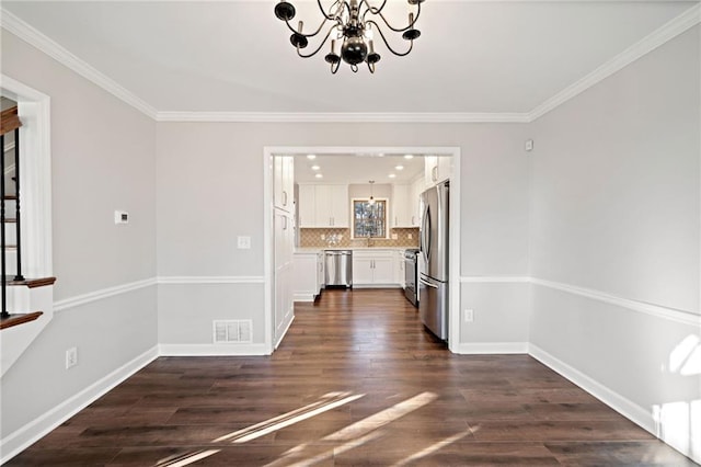 unfurnished dining area featuring crown molding, baseboards, visible vents, and dark wood-style flooring