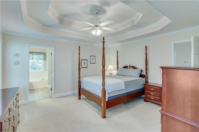 bedroom with ornamental molding, a tray ceiling, and light carpet