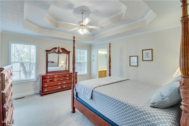 bedroom featuring a tray ceiling, ceiling fan, light carpet, and ornamental molding