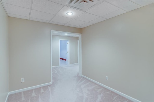 unfurnished room featuring visible vents, carpet, baseboards, and a drop ceiling