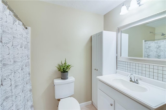 full bathroom featuring vanity, curtained shower, toilet, baseboards, and tile patterned floors