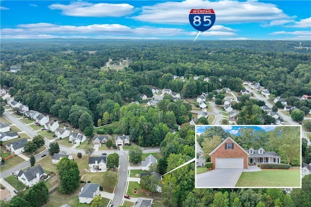 birds eye view of property featuring a view of trees
