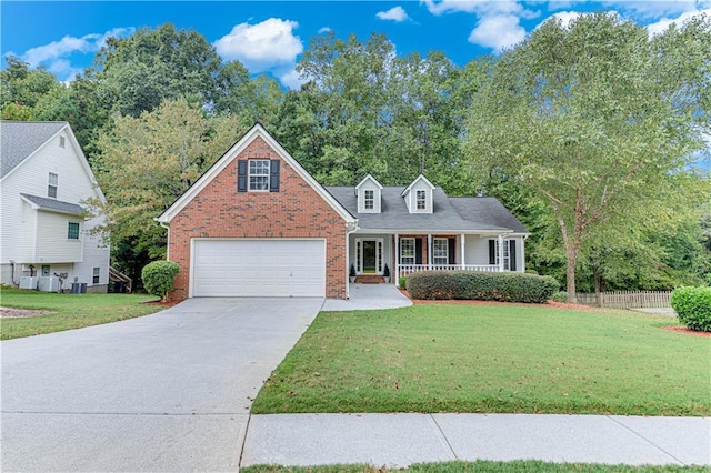 view of front of house featuring brick siding, covered porch, a front yard, and concrete driveway