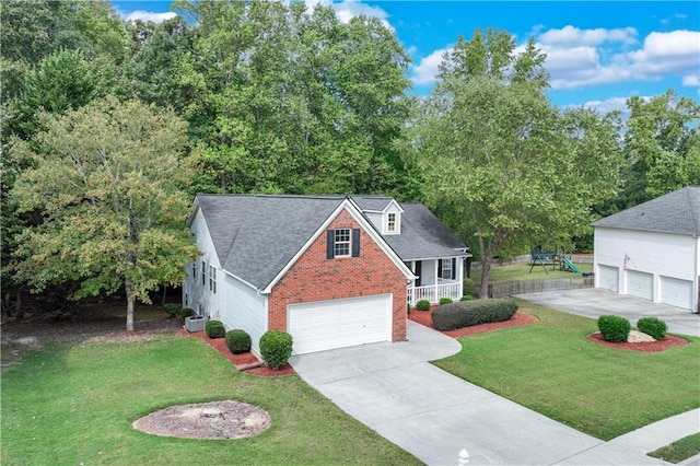 traditional-style house with a porch, a front yard, driveway, and brick siding