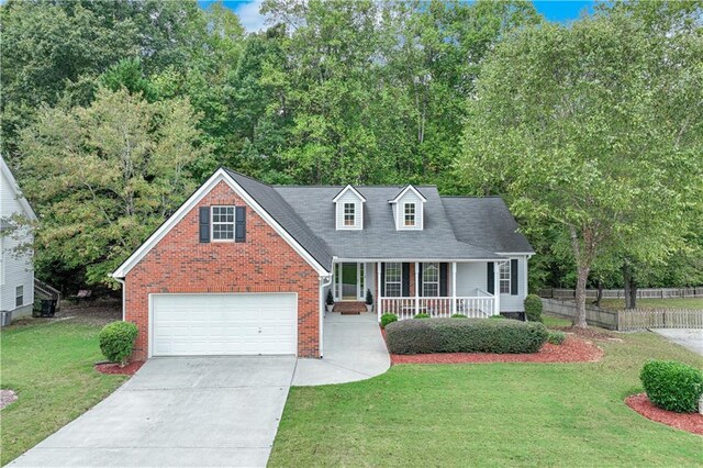 cape cod-style house with a garage, a front lawn, covered porch, brick siding, and driveway