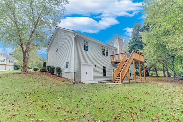 rear view of house featuring a yard, a wooden deck, stairs, and a chimney