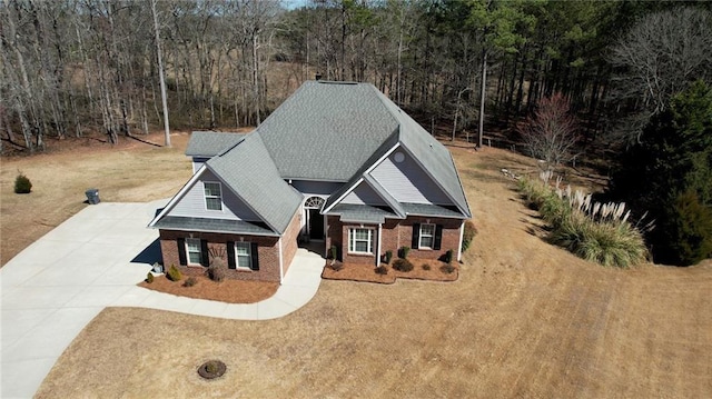 view of front of house featuring driveway and brick siding