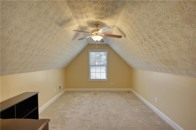 bonus room with visible vents and a textured ceiling