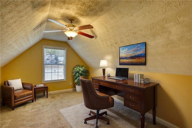 office featuring baseboards, lofted ceiling, ceiling fan, a textured ceiling, and carpet floors