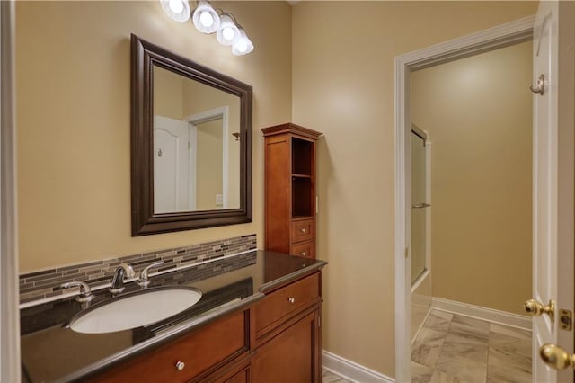 full bathroom with marble finish floor, baseboards, decorative backsplash, and vanity