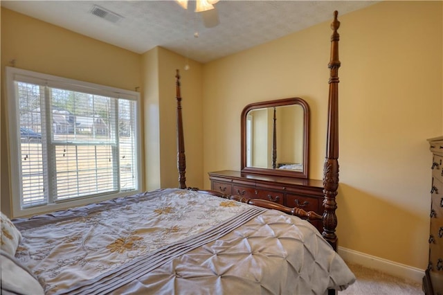 bedroom featuring carpet floors, visible vents, baseboards, and a ceiling fan