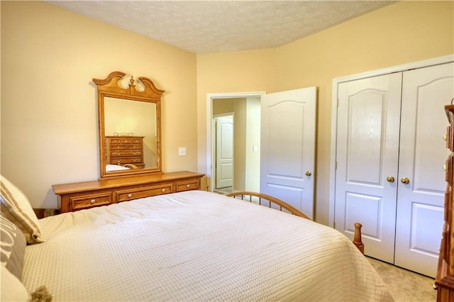 unfurnished bedroom with light carpet, a textured ceiling, and a closet