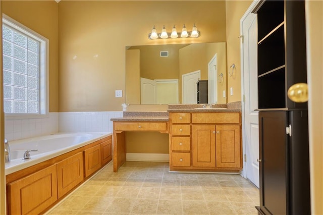 bathroom featuring tile patterned flooring, visible vents, vanity, and a bath