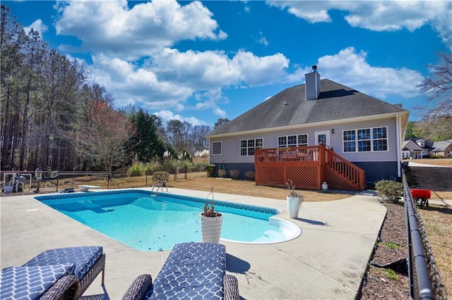 view of swimming pool with stairway, a patio area, a wooden deck, and a fenced in pool