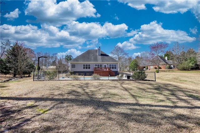 view of front of house with fence and a front lawn