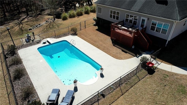 view of swimming pool featuring a diving board, a lawn, a fenced backyard, and a fenced in pool