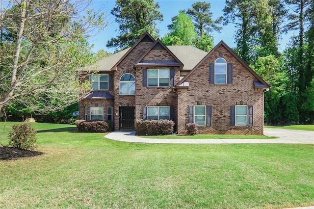 view of front of house featuring a front lawn and brick siding