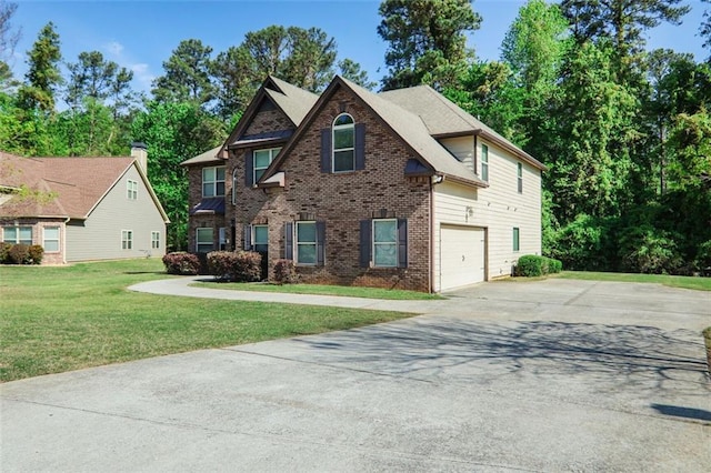 view of front of property featuring concrete driveway, a front yard, brick siding, and a garage