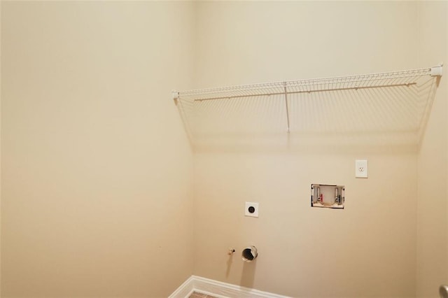 clothes washing area featuring laundry area, washer hookup, gas dryer hookup, hookup for an electric dryer, and baseboards