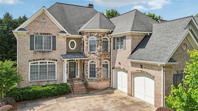 2871 Trailing Ivy Way, Buford, GA 30519 - view of front facade featuring roof with shingles, brick siding, driveway, and a garage