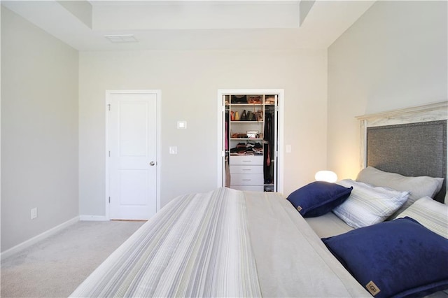 3313 Park Pointe Cir, Scottdale, GA 30079 - carpeted bedroom with a tray ceiling, a walk in closet, a closet, and baseboards