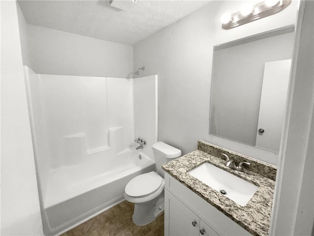 full bathroom with bathing tub / shower combination, vanity, a textured ceiling, and toilet