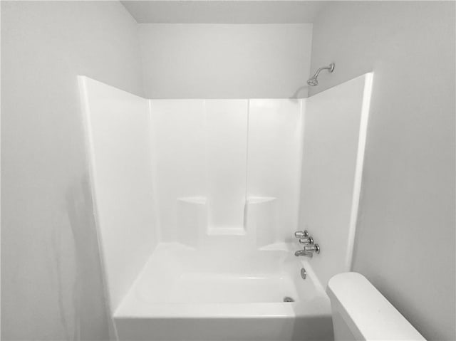 bathroom featuring shower / tub combination and toilet