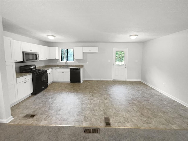 kitchen with white cabinetry, sink, and black appliances