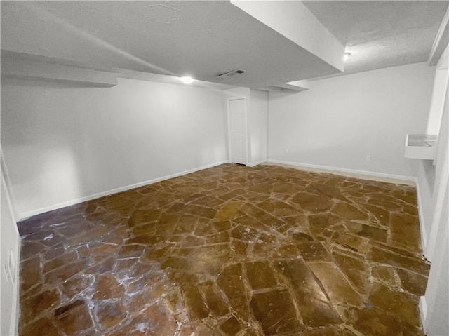 basement featuring a textured ceiling