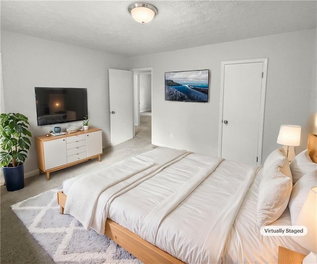 carpeted bedroom with a textured ceiling