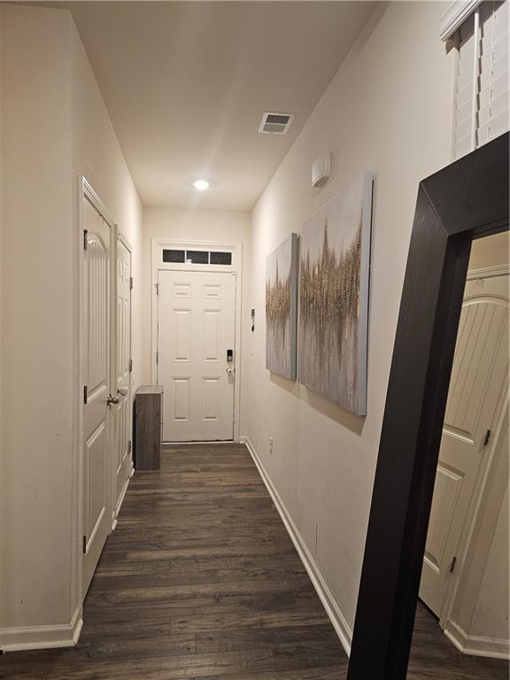 hall with dark hardwood / wood-style flooring