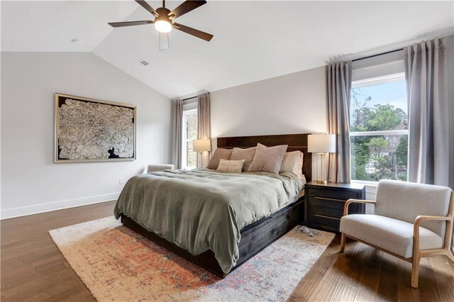 bedroom with vaulted ceiling, wood finished floors, a ceiling fan, and baseboards