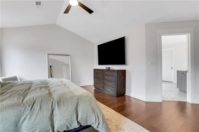 bedroom featuring dark wood-type flooring, visible vents, vaulted ceiling, and baseboards