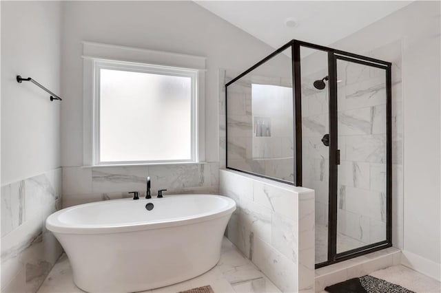 full bath featuring a stall shower, tile walls, marble finish floor, and a freestanding bath