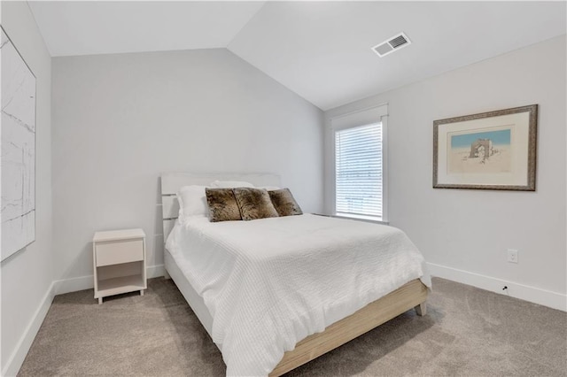 bedroom with carpet floors, lofted ceiling, visible vents, and baseboards