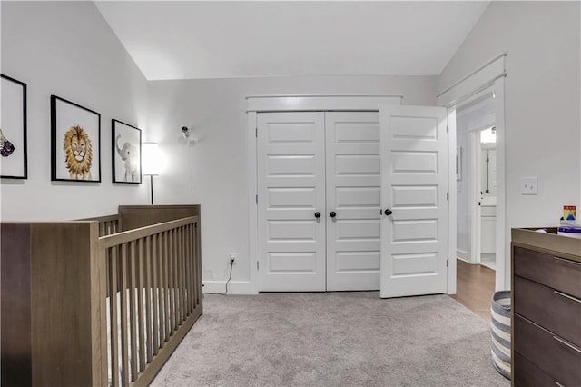 bedroom with a closet, carpet flooring, and baseboards