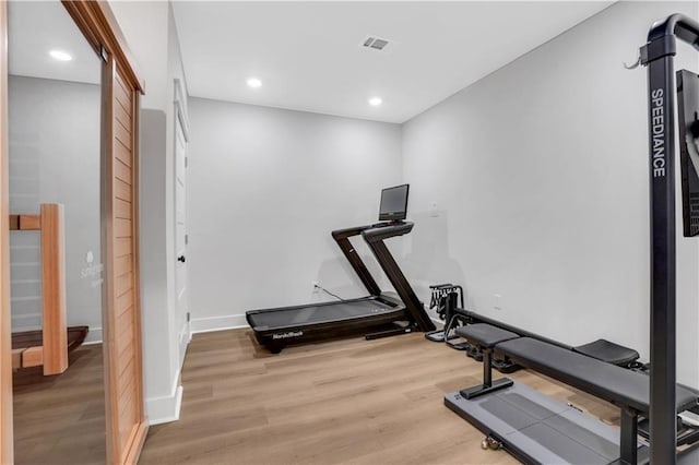 exercise room with recessed lighting, visible vents, light wood-style flooring, and baseboards