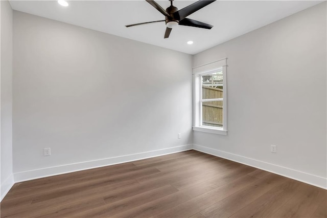 unfurnished room featuring recessed lighting, wood finished floors, a ceiling fan, and baseboards