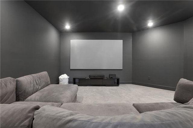 carpeted cinema room with recessed lighting and baseboards