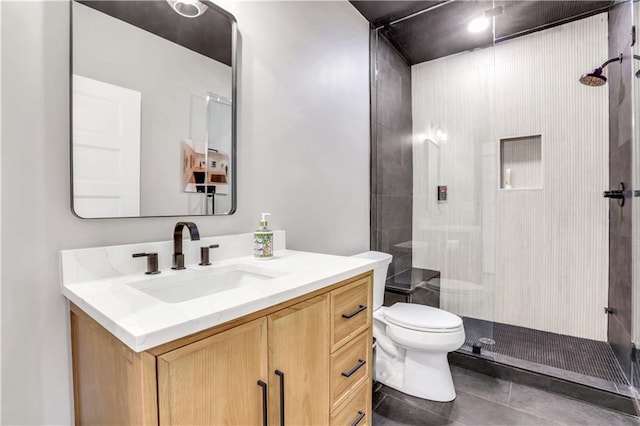 bathroom with vanity, walk in shower, toilet, and tile patterned floors